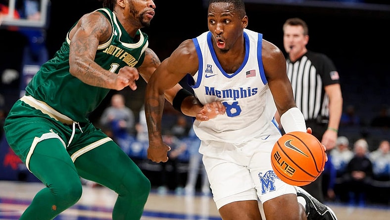 Jan 18, 2024; Memphis, Tennessee, USA; Memphis Tigers forward David Jones (8) drives to the basket against South Florida Bulls guard Selton Miguel (1) during the game between the University of South Florida and the University of Memphis at FedExForum. Mandatory Credit: Chris Day-USA TODAY Sports