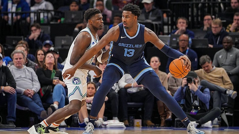 Jan 18, 2024; Minneapolis, Minnesota, USA; Minnesota Timberwolves guard Anthony Edwards (5) defends the Memphis Grizzlies forward Jaren Jackson Jr. (13) in the second quarter at Target Center. Mandatory Credit: Brad Rempel-USA TODAY Sports