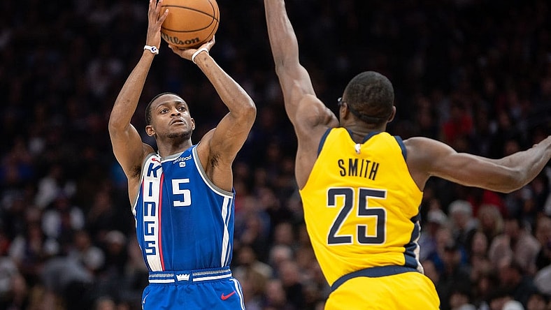 Jan 18, 2024; Sacramento, California, USA; Sacramento Kings guard De'Aaron Fox (5) takes a three point shot against Indiana Pacers forward Jalen Smith (25) during the second quarter at Golden 1 Center. Mandatory Credit: Ed Szczepanski-USA TODAY Sports