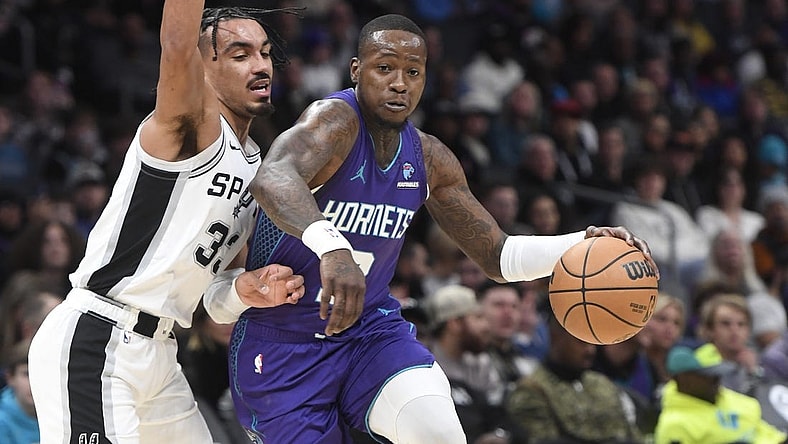 Jan 19, 2024; Charlotte, North Carolina, USA;  Charlotte Hornets guard Terry Rozier (3) moves in past the defense of San Antonio Spurs guard Tre Jones (33) during the first half at the Spectrum Center. Mandatory Credit: Sam Sharpe-USA TODAY Sports