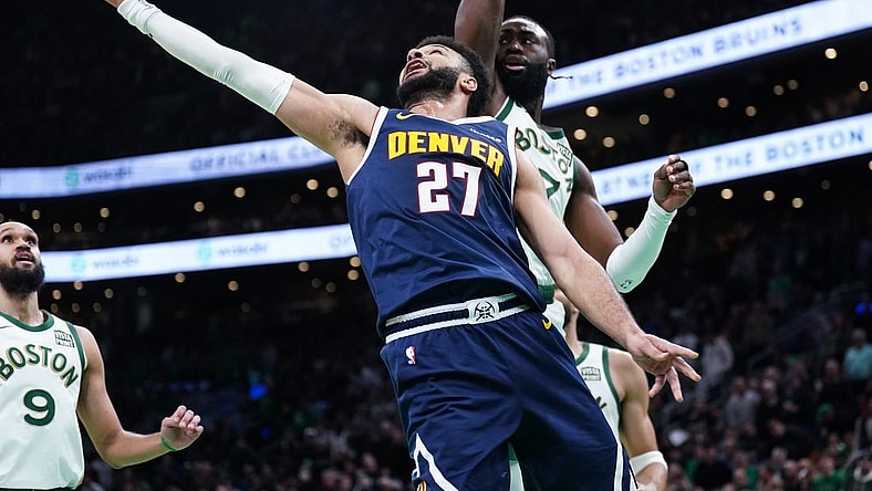 Jan 19, 2024; Boston, Massachusetts, USA; Denver Nuggets guard Jamal Murray (27) makes the basket against Boston Celtics guard Jaylen Brown (7) in the second quarter at TD Garden. Mandatory Credit: David Butler II-USA TODAY Sports