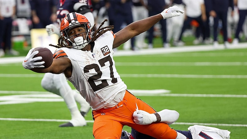 Jan 13, 2024; Houston, Texas, USA; Cleveland Browns running back Kareem Hunt (27) breaks the tackle of Houston Texans linebacker Christian Harris (48) as he scores a touchdown in a 2024 AFC wild card game at NRG Stadium. Mandatory Credit: Thomas Shea-USA TODAY Sports