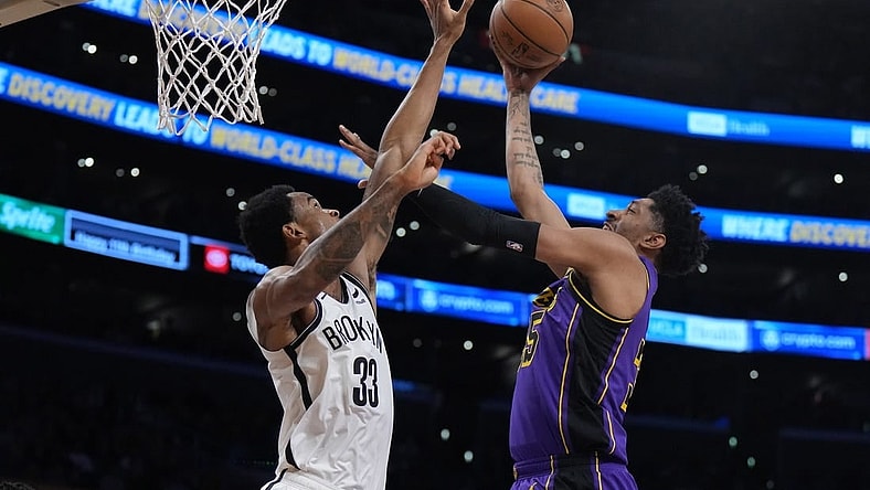Jan 19, 2024; Los Angeles, California, USA; Los Angeles Lakers forward Christian Wood (35) shoots the ball against Brooklyn Nets center Nic Claxton (33) in the first half at Crypto.com Arena. Mandatory Credit: Kirby Lee-USA TODAY Sports