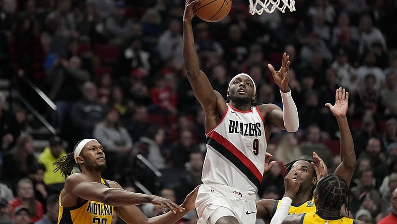 Jan 19, 2024; Portland, Oregon, USA; Portland Trail Blazers small forward Jerami Grant (9) shoots the ball past Indiana Pacers small forward Aaron Nesmith (23, right) during the second half at Moda Center. Mandatory Credit: Soobum Im-USA TODAY Sports