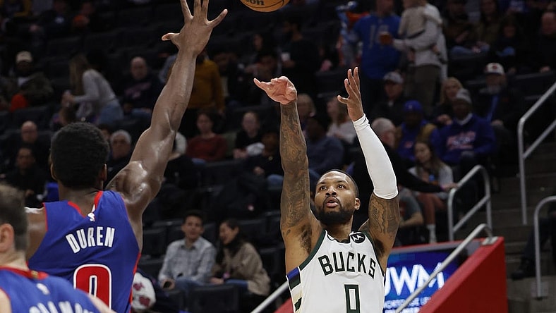Jan 20, 2024; Detroit, Michigan, USA;  Milwaukee Bucks guard Damian Lillard (0) shoots on Detroit Pistons center Jalen Duren (0) in the second half at Little Caesars Arena. Mandatory Credit: Rick Osentoski-USA TODAY Sports