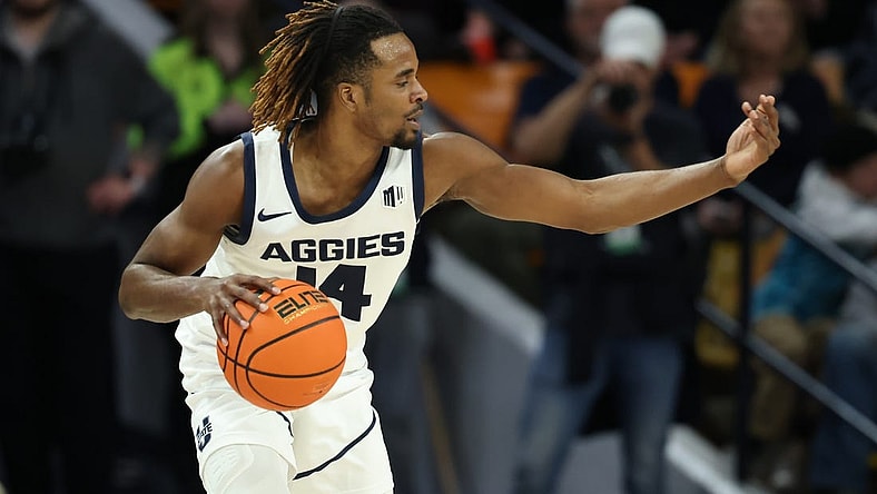 Jan 20, 2024; Logan, Utah, USA; Utah State Aggies guard Josh Uduje (14) calls a play against the Fresno State Bulldogs during the second half at Dee Glen Smith Spectrum. Mandatory Credit: Rob Gray-USA TODAY Sports