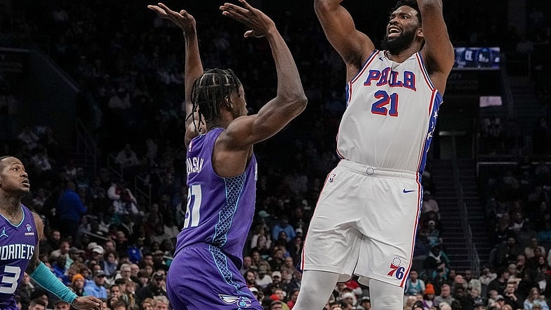 Jan 20, 2024; Charlotte, North Carolina, USA; Philadelphia 76ers center Joel Embiid (21) shoots over Charlotte Hornets center Nathan Mensah (31)during the second quarter at Spectrum Center. Mandatory Credit: Jim Dedmon-USA TODAY Sports