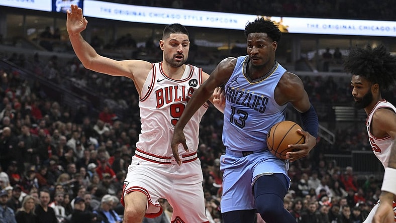 Jan 20, 2024; Chicago, Illinois, USA;  Chicago Bulls center Nikola Vucevic (9) defends against Memphis Grizzlies forward Jaren Jackson Jr. (13) during the first half at the United Center. Mandatory Credit: Matt Marton-USA TODAY Sports