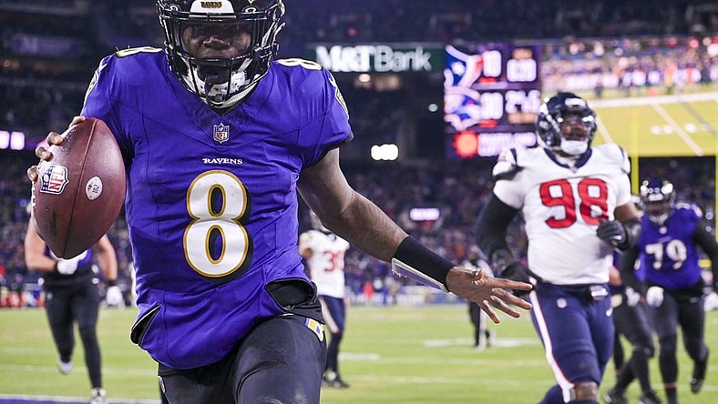 Jan 20, 2024; Baltimore, MD, USA; Baltimore Ravens quarterback Lamar Jackson (8) reacts after running past for Houston Texans defensive tackle Sheldon Rankins (98) for a touchdown during the fourth quarter  in a 2024 AFC divisional round game at M&T Bank Stadium. Mandatory Credit: Tommy Gilligan-USA TODAY Sports