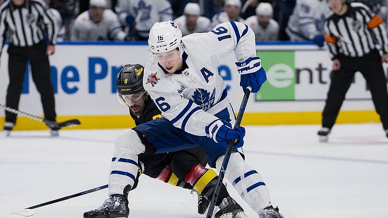 Jan 20, 2024; Vancouver, British Columbia, CAN; Vancouver Canucks forward Conor Garland (8) checks Toronto Maple Leafs forward Mitchell Marner (16) in the second period at Rogers Arena. Mandatory Credit: Bob Frid-USA TODAY Sports