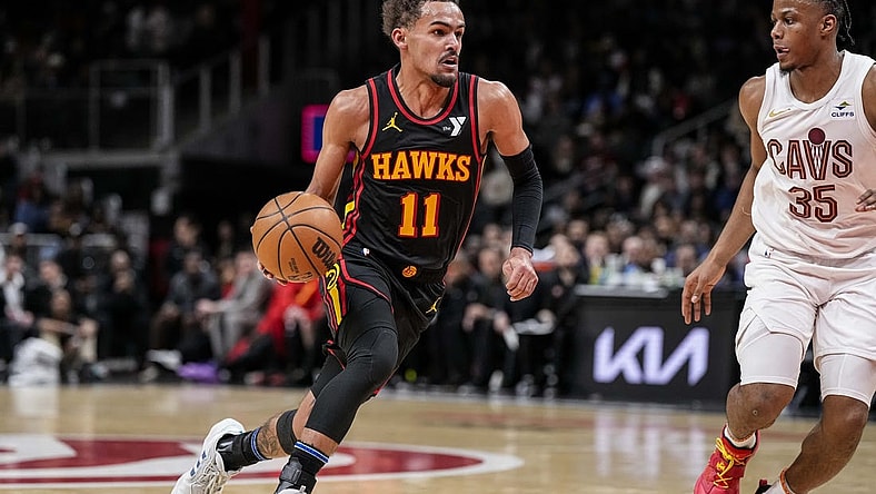 Jan 20, 2024; Atlanta, Georgia, USA; Atlanta Hawks guard Trae Young (11) dribbles against Cleveland Cavaliers forward Isaac Okoro (35) during the second half at State Farm Arena. Mandatory Credit: Dale Zanine-USA TODAY Sports