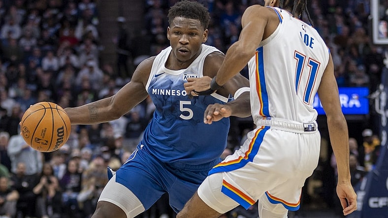 Jan 20, 2024; Minneapolis, Minnesota, USA; Minnesota Timberwolves guard Anthony Edwards (5) dribbles the ball as Oklahoma City Thunder guard Isaiah Joe (11) plays defense in the second half at Target Center. Mandatory Credit: Jesse Johnson-USA TODAY Sports