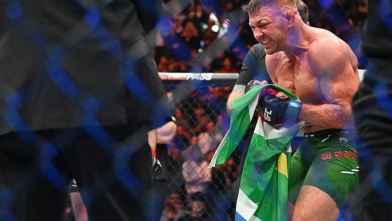 Jan 20, 2024; Toronto, Canada, USA; Dricus Du Plessis (blue gloves) celebrates defeating Sean Strickland (red glove) during UFC 297 at ScotiaBank Arena. Mandatory Credit: Dan Hamilton-USA TODAY Sports