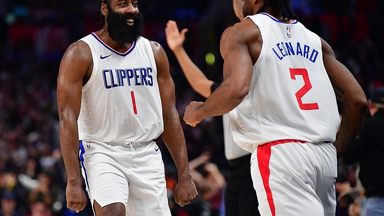 Jan 21, 2024; Los Angeles, California, USA; Los Angeles Clippers guard James Harden (1) reacts after forward Kawhi Leonard (2) scores three point basket against the Brooklyn Nets during the second half at Crypto.com Arena. Mandatory Credit: Gary A. Vasquez-USA TODAY Sports
