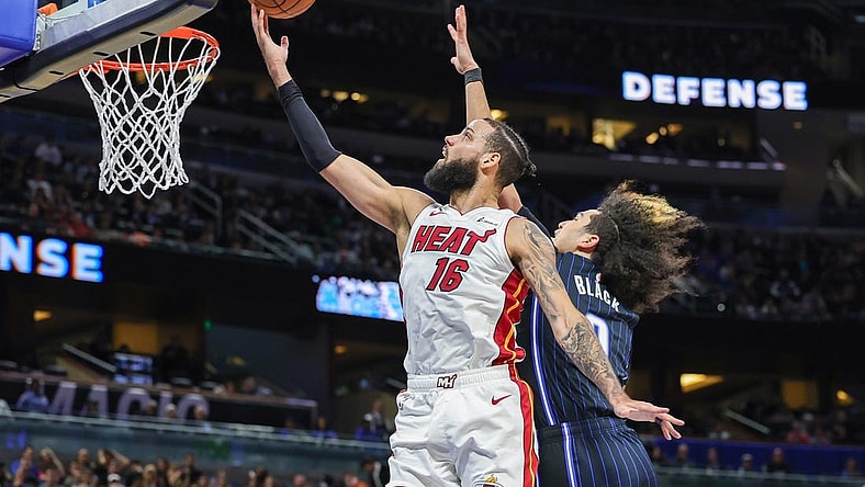 Jan 21, 2024; Orlando, Florida, USA; Miami Heat forward Caleb Martin (16) goes to the basket against Orlando Magic guard Anthony Black (0) during the second quarter at Amway Center. Mandatory Credit: Mike Watters-USA TODAY Sports