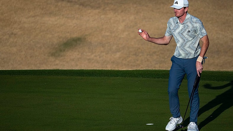 Nick Dunlap gestures to the gallery after putting for a birdie on the 16th green on the Pete Dye Stadium Course during the final round of The American Express at PGA West in La Quinta, Calif., Sunday, Jan. 21, 2024.