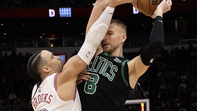 Jan 21, 2024; Houston, Texas, USA; Boston Celtics center Kristaps Porzingis (8) is guarded by Houston Rockets forward Dillon Brooks (9) in the second half at Toyota Center. Mandatory Credit: Thomas Shea-USA TODAY Sports