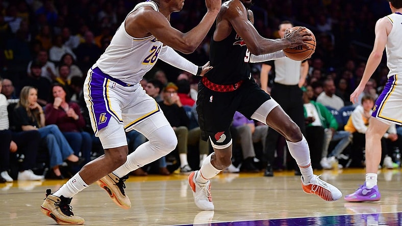 Jan 21, 2024; Los Angeles, California, USA; Portland Trail Blazers forward Jerami Grant (9) moves the ball against Los Angeles Lakers forward Rui Hachimura (28) during the first half at Crypto.com Arena. Mandatory Credit: Gary A. Vasquez-USA TODAY Sports