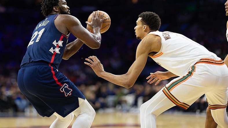 Jan 22, 2024; Philadelphia, Pennsylvania, USA; Philadelphia 76ers center Joel Embiid (21) shoots against San Antonio Spurs center Victor Wembanyama (1) during the second quarter at Wells Fargo Center. Mandatory Credit: Bill Streicher-USA TODAY Sports