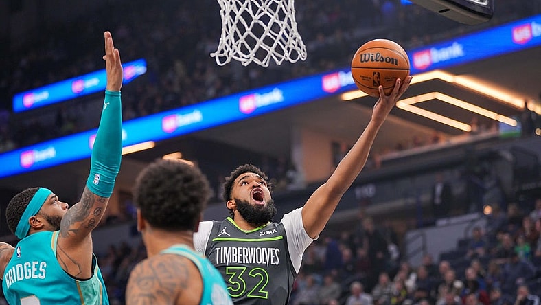 Jan 22, 2024; Minneapolis, Minnesota, USA; Minnesota Timberwolves center Karl-Anthony Towns (32) shoots against the Charlotte Hornets in the first quarter at Target Center. Mandatory Credit: Brad Rempel-USA TODAY Sports