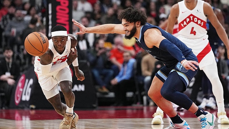 Jan 22, 2024; Toronto, Ontario, CAN; Toronto Raptors guard Dennis Schroder (17) battles for the ball with Memphis Grizzlies forward David Roddy (21) during the first quarter at Scotiabank Arena. Mandatory Credit: Nick Turchiaro-USA TODAY Sports