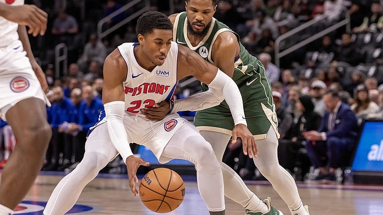 Jan 22, 2024; Detroit, Michigan, USA; Detroit Pistons guard Jaden Ivey (23) protects the ball from Milwaukee Bucks guard Malik Beasley (5) during the first quarter at Little Caesars Arena. Mandatory Credit: David Reginek-USA TODAY Sports