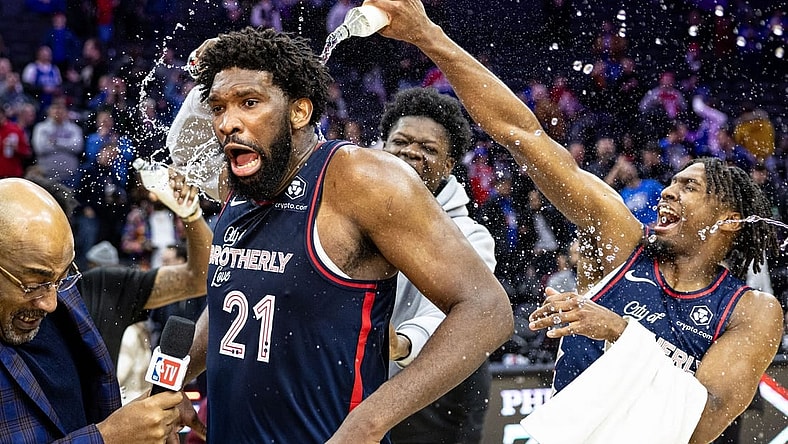 Jan 22, 2024; Philadelphia, Pennsylvania, USA; Philadelphia 76ers center Joel Embiid (21) is doused with water by teammates after scoring 70 points in a victory against the San Antonio Spurs at Wells Fargo Center. Mandatory Credit: Bill Streicher-USA TODAY Sports