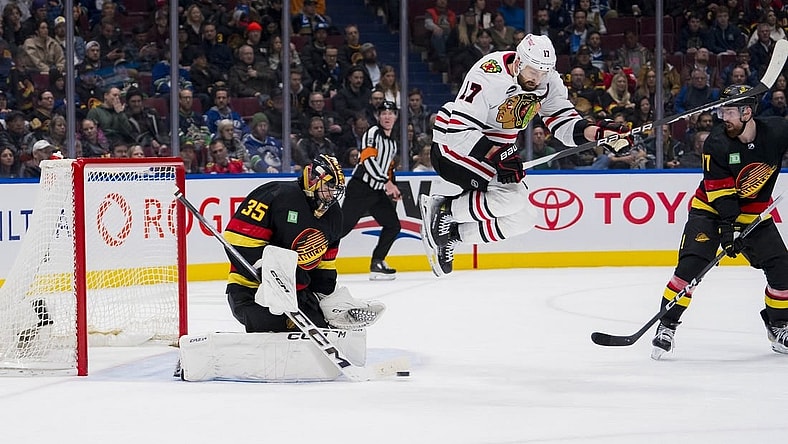 Jan 22, 2024; Vancouver, British Columbia, CAN; Vancouver Canucks defenseman Filip Hronek (17) watches as goalie Thatcher Demko (35) makes a save behind leaping Chicago Blackhawks forward Nick Foligno (17) in the second period at Rogers Arena. Mandatory Credit: Bob Frid-USA TODAY Sports