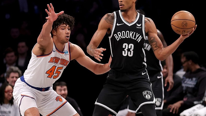 Jan 23, 2024; Brooklyn, New York, USA; Brooklyn Nets center Nic Claxton (33) looks to pass the ball against New York Knicks center Jericho Sims (45) during the first quarter at Barclays Center. Mandatory Credit: Brad Penner-USA TODAY Sports