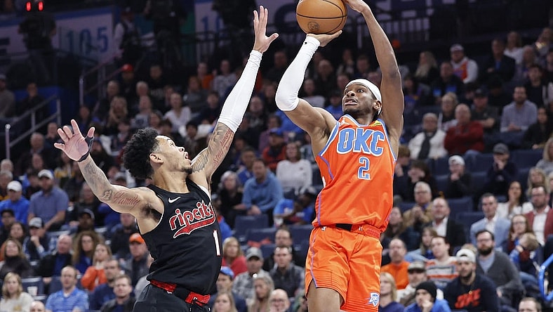 Jan 23, 2024; Oklahoma City, Oklahoma, USA; Oklahoma City Thunder guard Shai Gilgeous-Alexander (2) shoots as Portland Trail Blazers guard Anfernee Simons (1) defends during the second half at Paycom Center. Mandatory Credit: Alonzo Adams-USA TODAY Sports