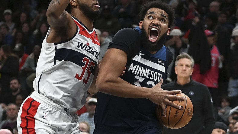 Jan 24, 2024; Washington, District of Columbia, USA; Minnesota Timberwolves center Karl-Anthony Towns (32) move to the the basket on Washington Wizards forward Marvin Bagley III (35) during the first half  at Capital One Arena. Mandatory Credit: Tommy Gilligan-USA TODAY Sports