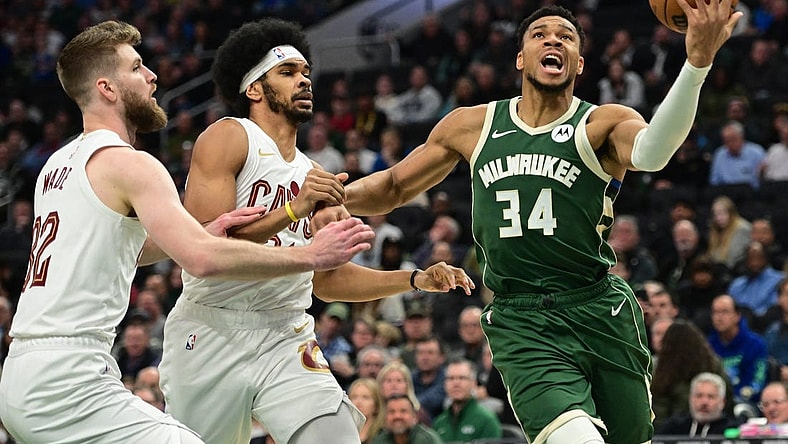 Jan 24, 2024; Milwaukee, Wisconsin, USA;  Milwaukee Bucks forward Giannis Antetokounmpo (34) takes a shot against Cleveland Cavaliers forward Dean Wade (32) and center Jarrett Allen (31) in the first quarter at Fiserv Forum. Mandatory Credit: Benny Sieu-USA TODAY Sports