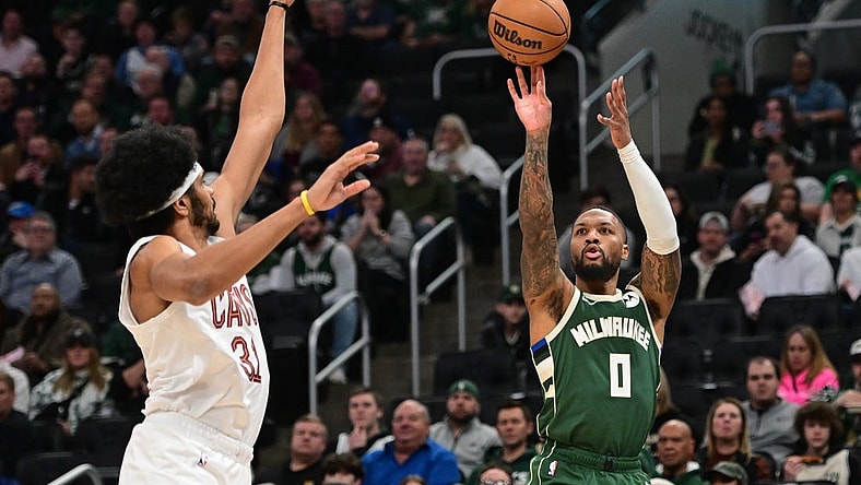Jan 24, 2024; Milwaukee, Wisconsin, USA;  Milwaukee Bucks guard Damian Lillard (0) takes a shot against Cleveland Cavaliers center Jarrett Allen (31) in the first quarter at Fiserv Forum. Mandatory Credit: Benny Sieu-USA TODAY Sports