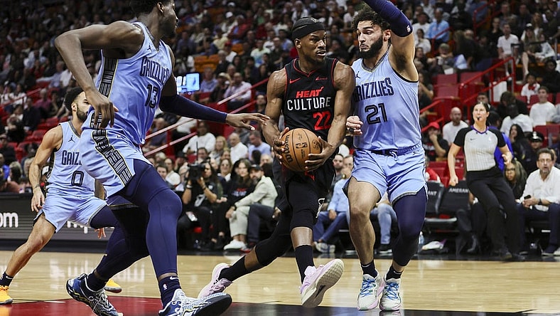 Jan 24, 2024; Miami, Florida, USA; Miami Heat forward Jimmy Butler (22) drives to the basket against Memphis Grizzlies forward David Roddy (21) during the second quarter at Kaseya Center. Mandatory Credit: Sam Navarro-USA TODAY Sports