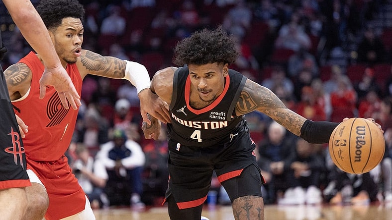 Jan 24, 2024; Houston, Texas, USA; Houston Rockets guard Jalen Green (4) dribbles against Portland Trail Blazers guard Anfernee Simons (1) in the first quarter at Toyota Center. Mandatory Credit: Thomas Shea-USA TODAY Sports