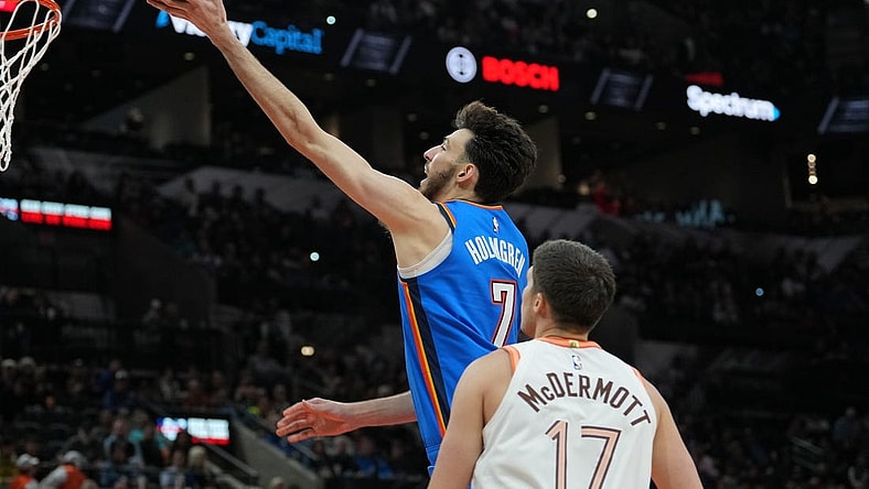 Jan 24, 2024; San Antonio, Texas, USA;  Oklahoma City Thunder forward Chet Holmgren (7) shoots in front of San Antonio Spurs forward Doug McDermott (17) in the second half at Frost Bank Center. Mandatory Credit: Daniel Dunn-USA TODAY Sports