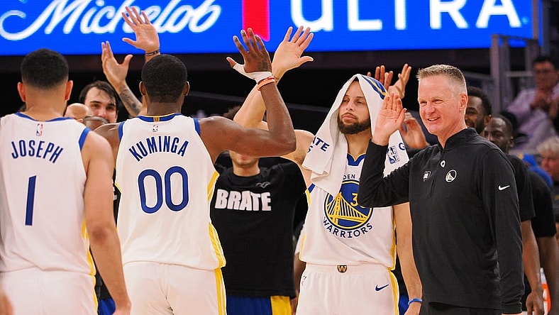 Jan 24, 2024; San Francisco, California, USA; Golden State Warriors forward Jonathan Kuminga (00) high fives guard Stephen Curry (30) and head coach Steve Kerr as a time out is called against the Atlanta Hawks during the fourth quarter at Chase Center. Mandatory Credit: Kelley L Cox-USA TODAY Sports