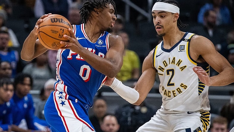Jan 25, 2024; Indianapolis, Indiana, USA; Philadelphia 76ers guard Tyrese Maxey (0) drives to the basket while Indiana Pacers guard Andrew Nembhard (2) defends in the first half at Gainbridge Fieldhouse. Mandatory Credit: Trevor Ruszkowski-USA TODAY Sports