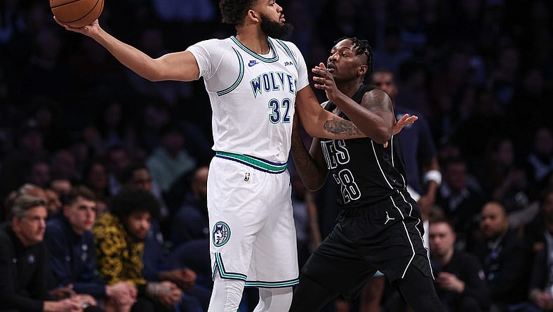 Jan 25, 2024; Brooklyn, New York, USA; Minnesota Timberwolves center Karl-Anthony Towns (32) shields the ball from Brooklyn Nets forward Dorian Finney-Smith (28) during the first quarter at Barclays Center. Mandatory Credit: Vincent Carchietta-USA TODAY Sports