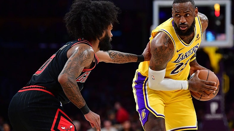 Jan 25, 2024; Los Angeles, California, USA; Los Angeles Lakers forward LeBron James (23) controls the ball against Chicago Bulls guard Coby White (0) during the first half at Crypto.com Arena. Mandatory Credit: Gary A. Vasquez-USA TODAY Sports