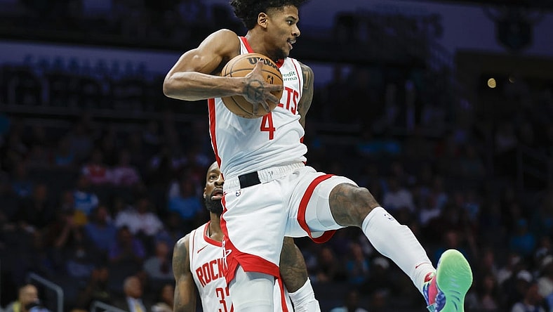 Jan 26, 2024; Charlotte, North Carolina, USA; Houston Rockets guard Jalen Green (4) pulls down a rebound against the Charlotte Hornets during the first quarter at Spectrum Center. Mandatory Credit: Nell Redmond-USA TODAY Sports