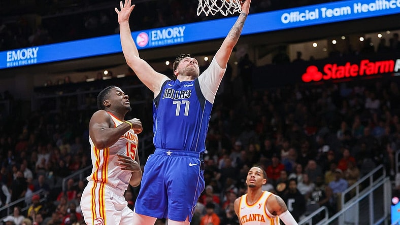 Jan 26, 2024; Atlanta, Georgia, USA; Dallas Mavericks guard Luka Doncic (77) shoots against the Atlanta Hawks in the second quarter at State Farm Arena. Mandatory Credit: Brett Davis-USA TODAY Sports