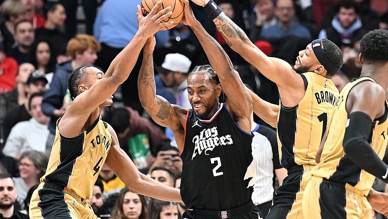 Jan 26, 2024; Toronto, Ontario, CAN;   Los Angeles Clippers forward Kawhi Leonard (2) battles for the ball against Toronto Raptors forward Scottie Barnes (4) and guard Bruce Brown (11) in the first half at Scotiabank Arena. Mandatory Credit: Dan Hamilton-USA TODAY Sports