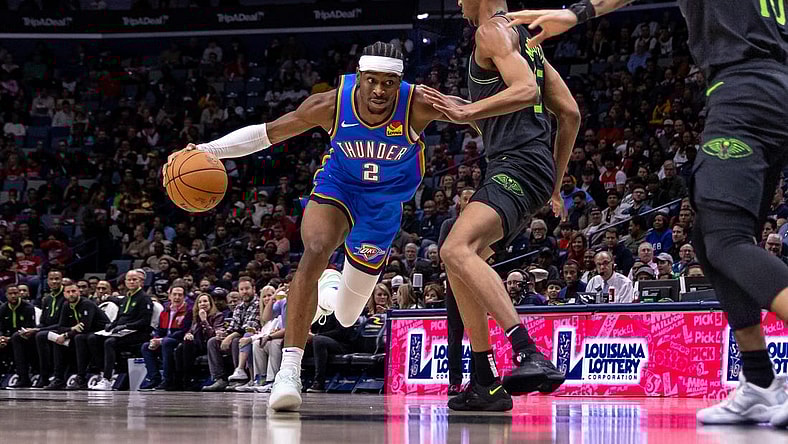 Jan 26, 2024; New Orleans, Louisiana, USA; Oklahoma City Thunder guard Shai Gilgeous-Alexander (2) dribbles against New Orleans Pelicans guard Trey Murphy III (25) during the first half at Smoothie King Center. Mandatory Credit: Stephen Lew-USA TODAY Sports