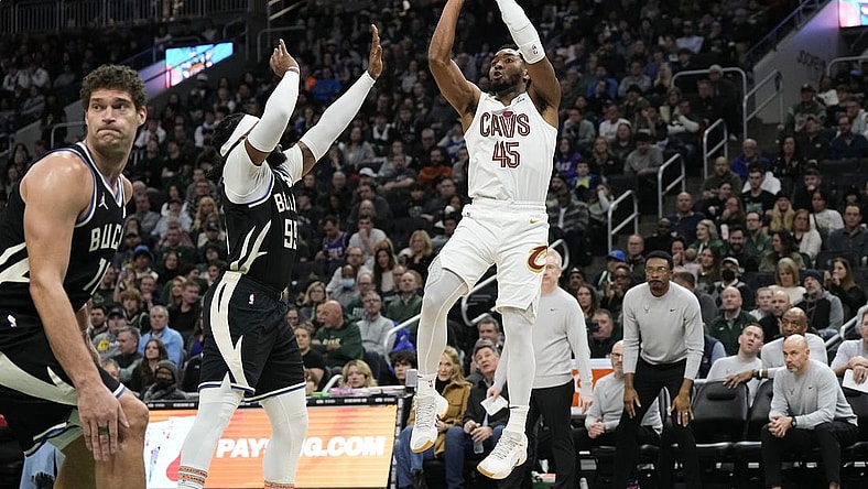 Jan 26, 2024; Milwaukee, Wisconsin, USA;  Cleveland Cavaliers guard Donovan Mitchell (45) shoots against Milwaukee Bucks forward Jae Crowder (99) during the third quarter at Fiserv Forum. Mandatory Credit: Jeff Hanisch-USA TODAY Sports