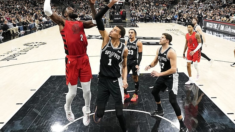 Jan 26, 2024; San Antonio, Texas, USA; Portland Trail Blazers center Deandre Ayton (2) shoots over San Antonio Spurs forward Victor Wembanyama (1) during the first half at Frost Bank Center. Mandatory Credit: Scott Wachter-USA TODAY Sports