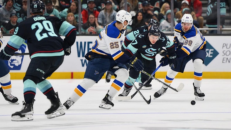 Jan 26, 2024; Seattle, Washington, USA; St. Louis Blues center Jordan Kyrou (25) and Seattle Kraken center Yanni Gourde (37) and St. Louis Blues left wing Pavel Buchnevich (89) chase the puck during the third period at Climate Pledge Arena. Mandatory Credit: Steven Bisig-USA TODAY Sports