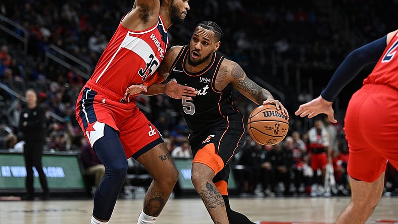 Jan 27, 2024; Detroit, Michigan, USA; Detroit Pistons guard Monte Morris (5) drives to the basket against Washington Wizards forward Marvin Bagley III (35) in the first quarter at Little Caesars Arena. Mandatory Credit: Lon Horwedel-USA TODAY Sports