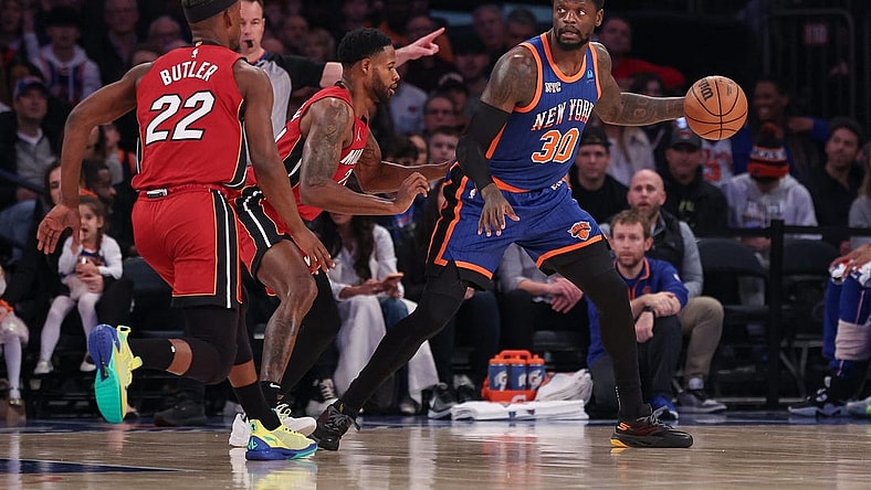 Jan 27, 2024; New York, New York, USA; New York Knicks forward Julius Randle (30) controls the ball as Miami Heat forward Haywood Highsmith (24) and forward Jimmy Butler (22) defend during the first half at Madison Square Garden. Mandatory Credit: Vincent Carchietta-USA TODAY Sports