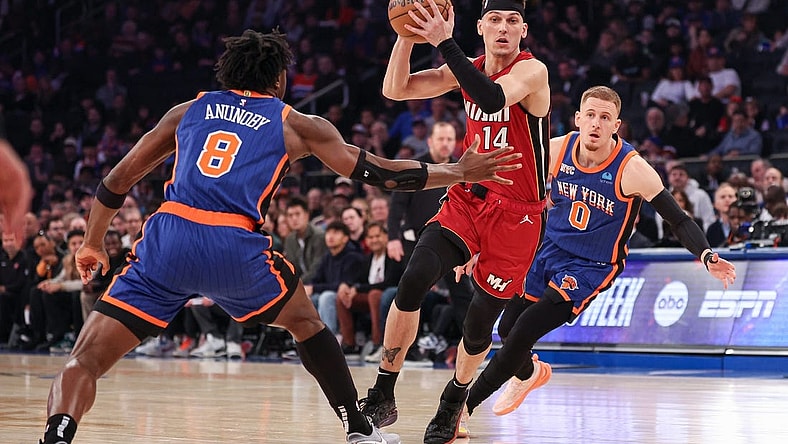 Jan 27, 2024; New York, New York, USA; Miami Heat guard Tyler Herro (14) drives to the basket after the game New York Knicks forward OG Anunoby (8) and guard Donte DiVincenzo (0) during the first half at Madison Square Garden. Mandatory Credit: Vincent Carchietta-USA TODAY Sports
